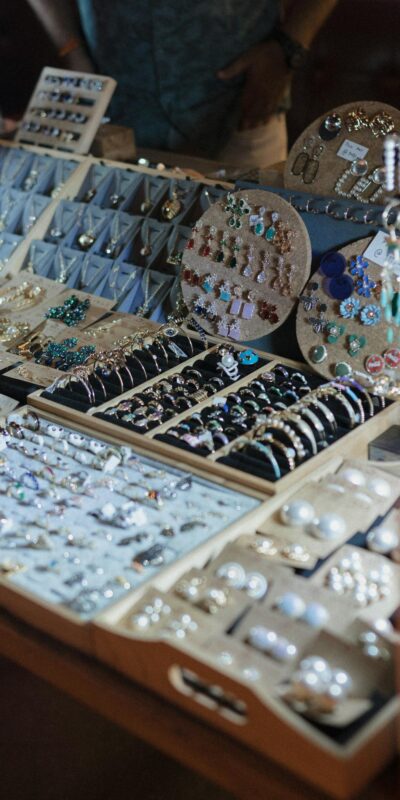 A close-up of a jewelry display showcasing a variety of handcrafted earrings and rings.