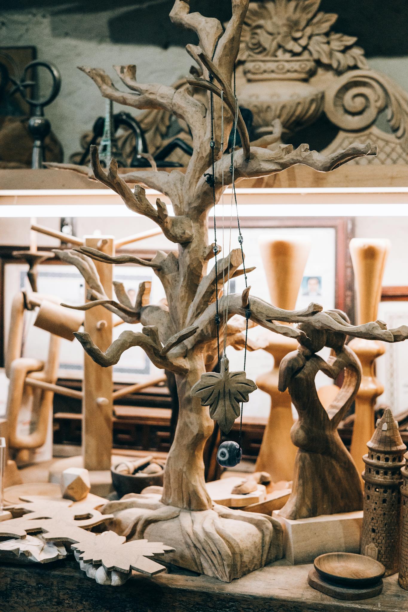 Wooden sculptures and carvings arranged in an artisan's workshop, showcasing craftsmanship.